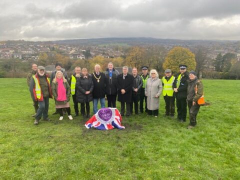 Group photo of all in attendance with plaque before unveiling draped in a platinum jubilee union jack flag 