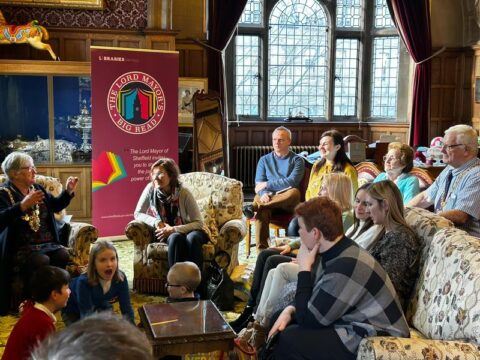 Photo of seated group of adults and children talking in the Lord Mayors parlour